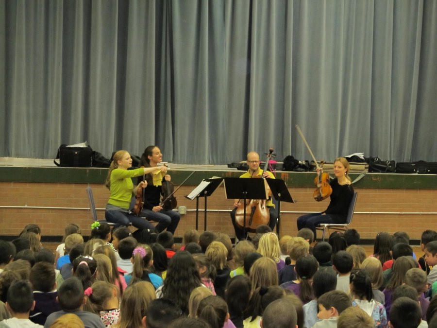 Brightin Rose Schlumpf performing for a school audience